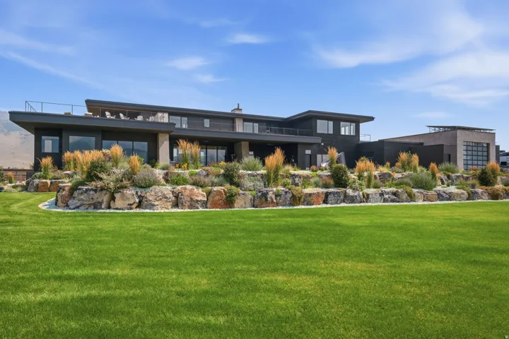 Expansive lawn with rock landscaping and varied plantings