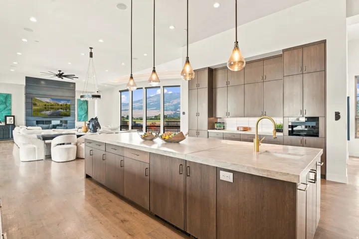 Expansive kitchen island with an integrated sink and gold-finish faucet