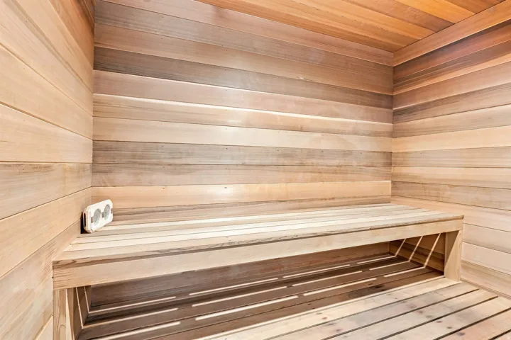 Wood-paneled interior featuring a built-in bench and slatted flooring