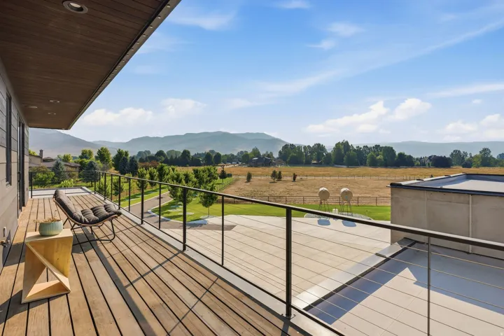 Expansive outdoor deck with wood-finish flooring and cable railings
