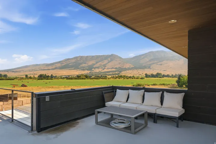 Expansive outdoor terrace featuring a wood-panel ceiling, recessed lighting, and a durable composite railing system