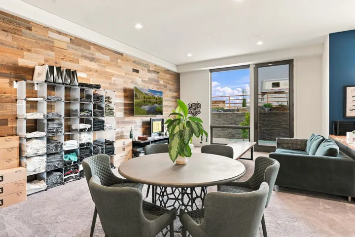 Reclaimed wood accent wall, recessed lighting, expansive glass door, large window, and carpeted flooring