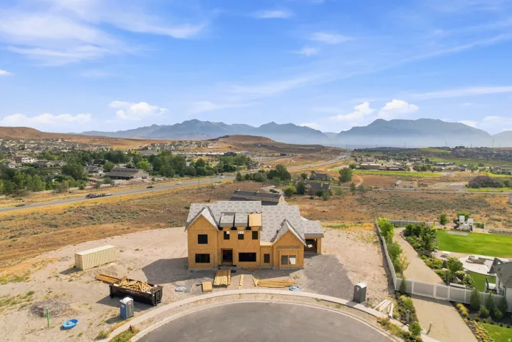 New construction residence featuring a distinctive gabled roof with views of the Wasatch Mountains