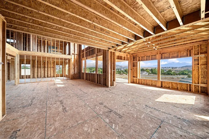 Expansive open-concept interior with abundant natural light from multiple large windows, and views throughout