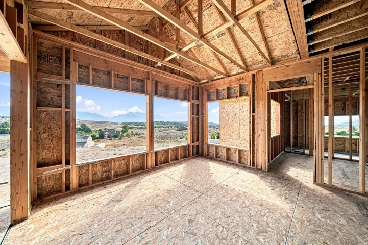 Expansive open-concept interior with abundant natural light from multiple large windows, and views throughout