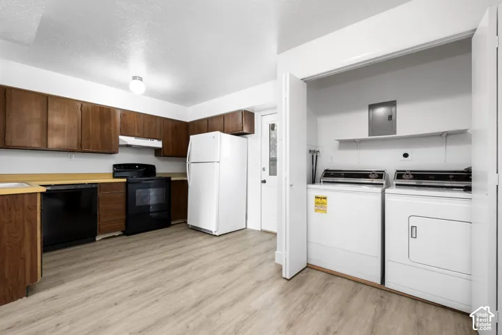 2984 - Kitchen featuring wood-finish cabinetry, black appliances, and light wood-finish flooring