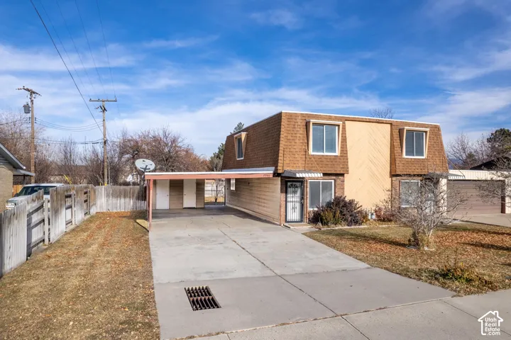 2986 - Split-level residence featuring a carport, concrete driveway, and a fenced yard