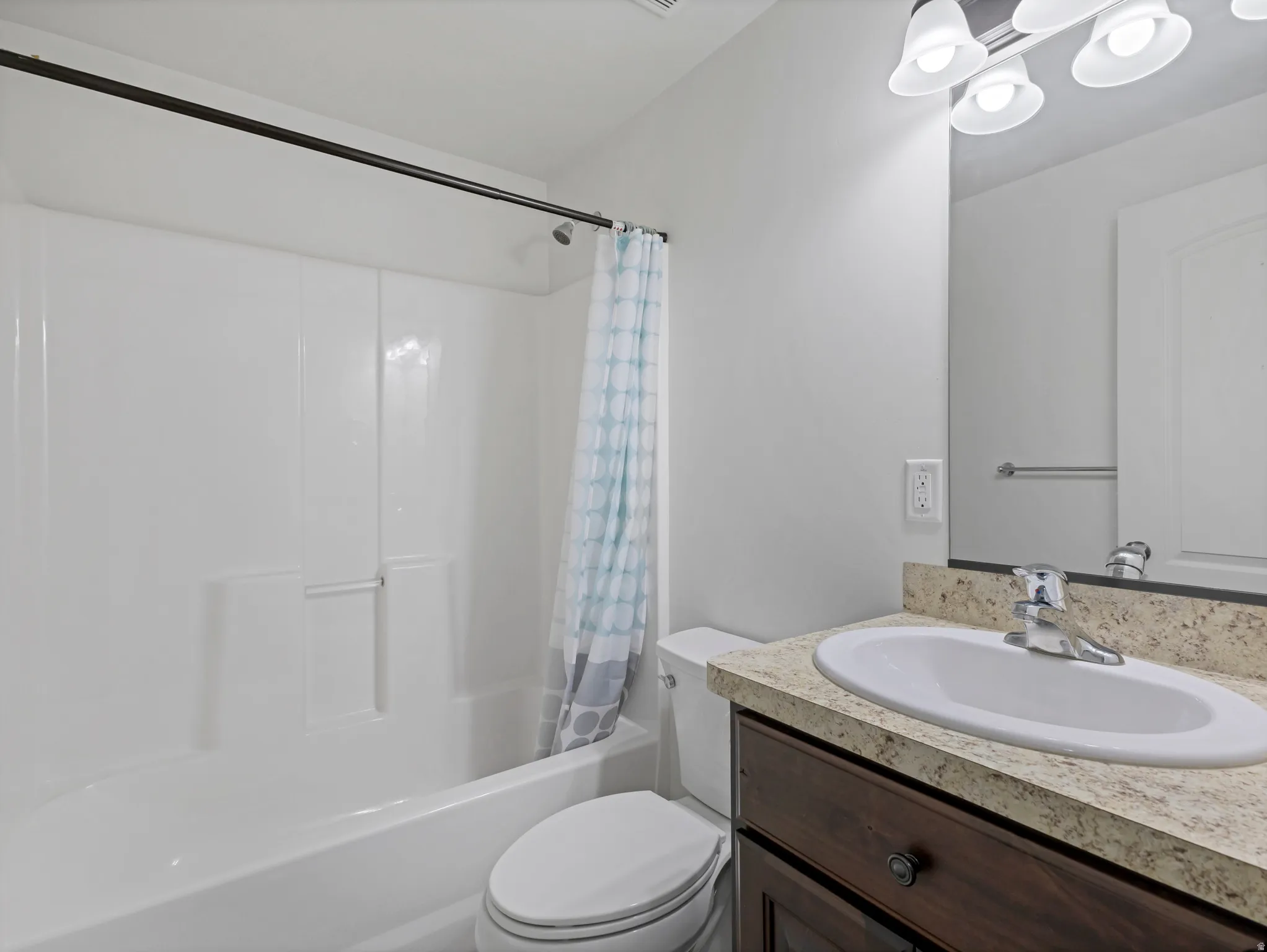 White shower/tub combination with a dark-finished shower rod