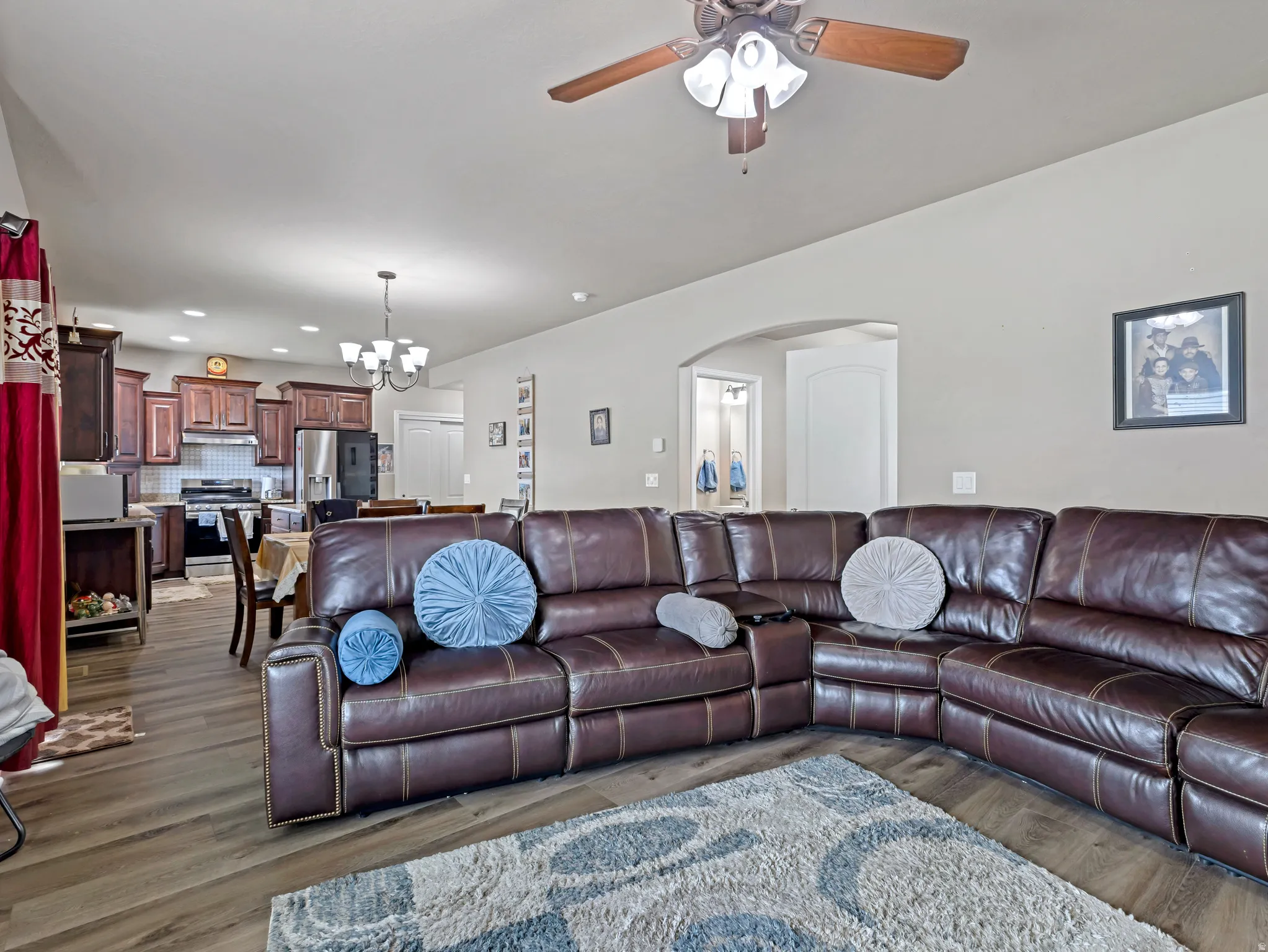 Wood-finish flooring, recessed lighting, and a ceiling fan with integrated lighting
