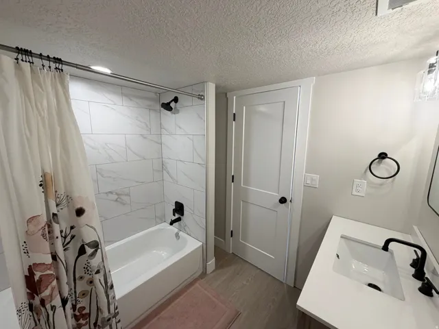 White vanity with a rectangular undermount sink and matte black faucet