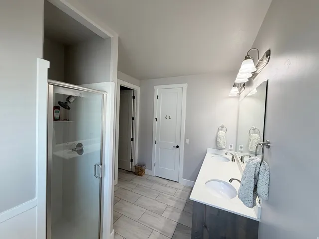 Dual vanity with undermount sinks, stone-finish countertop, and brushed nickel fixtures