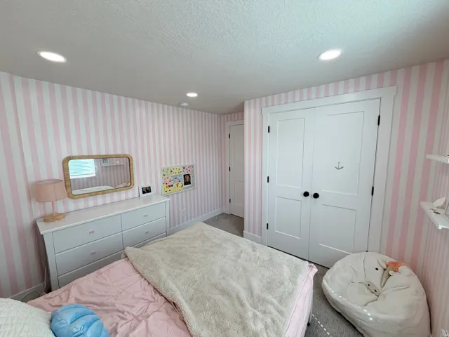 Recessed lighting, painted white trim, white paneled doors, and wall-to-wall carpeting