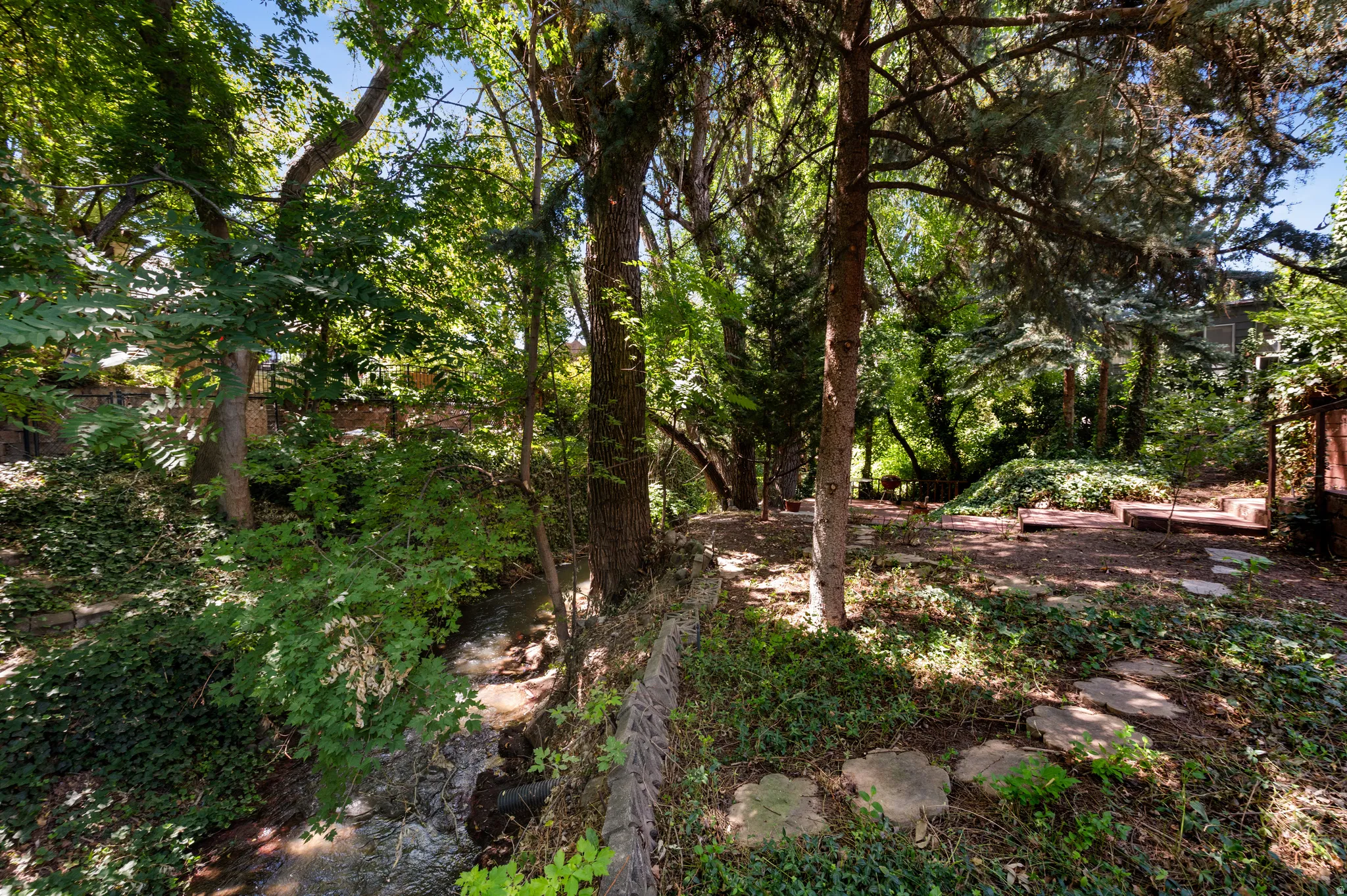 A private path leads all the way to the water, making Mill Creek part of everyday life.