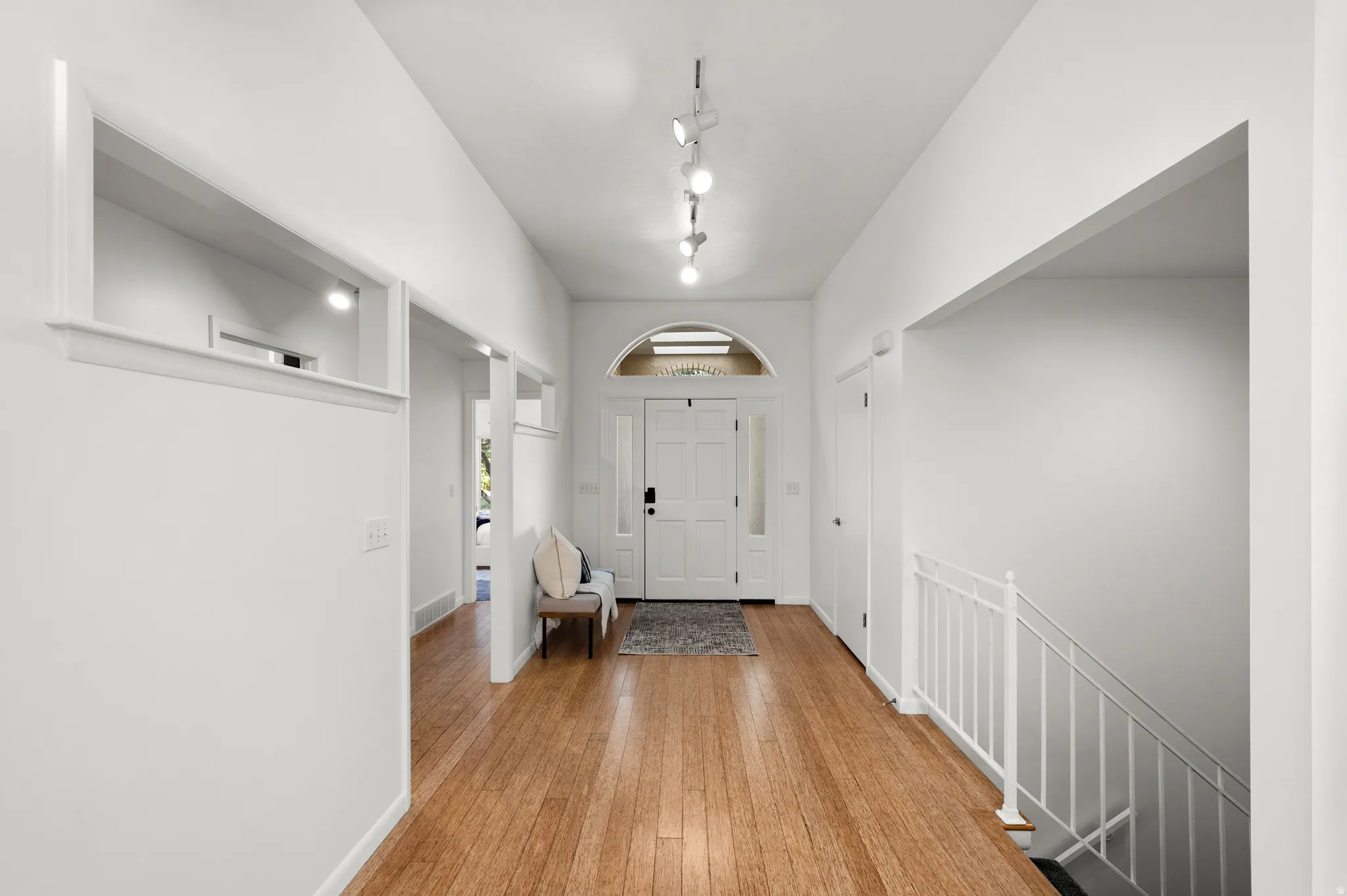 A bright, welcoming entry introduces the home's open main-level floor plan and warm bamboo flooring.