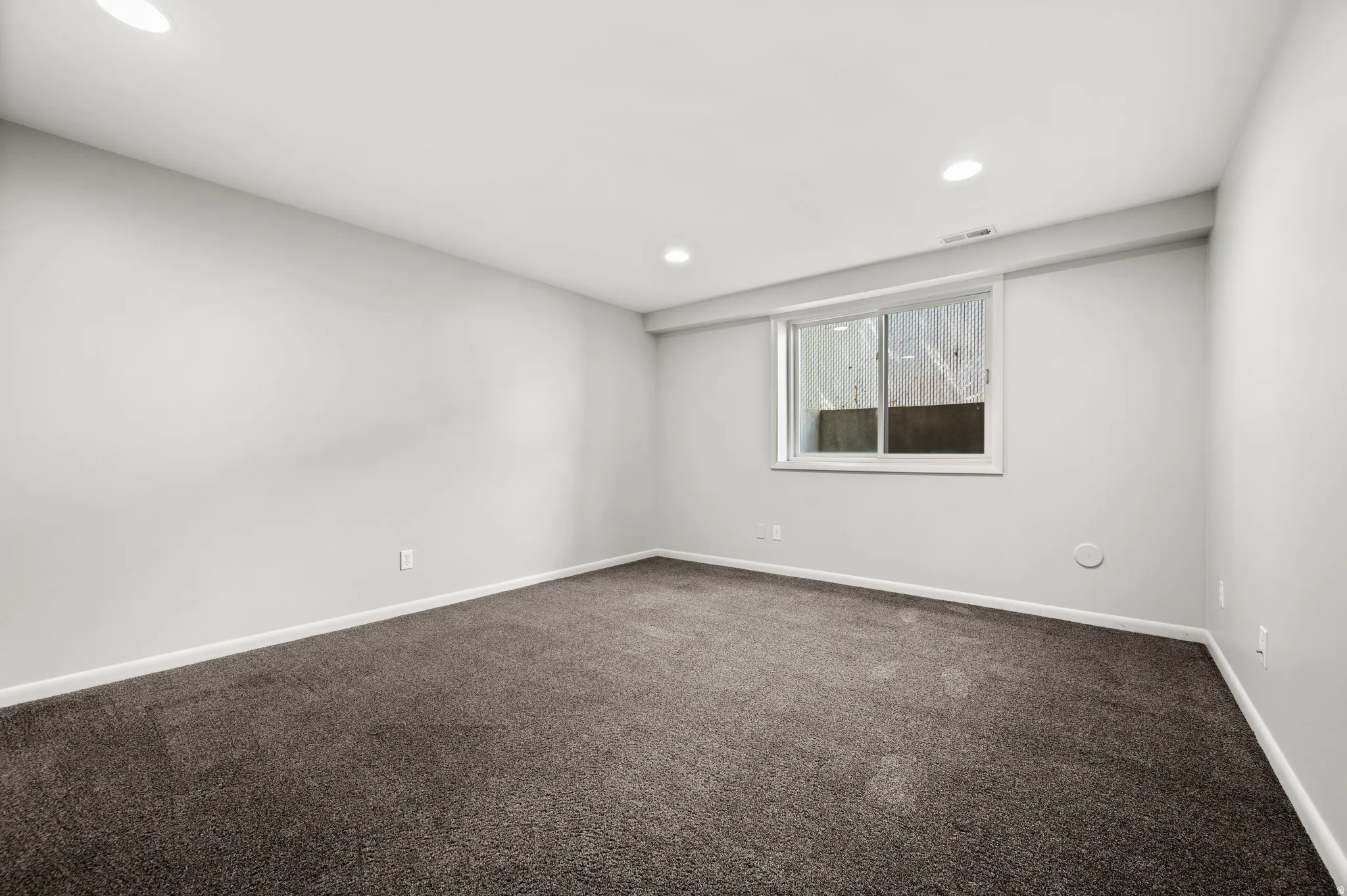 A second lower-level bedroom.The expansive covered porch creates a wonderful outdoor living space surrounded by mature trees.