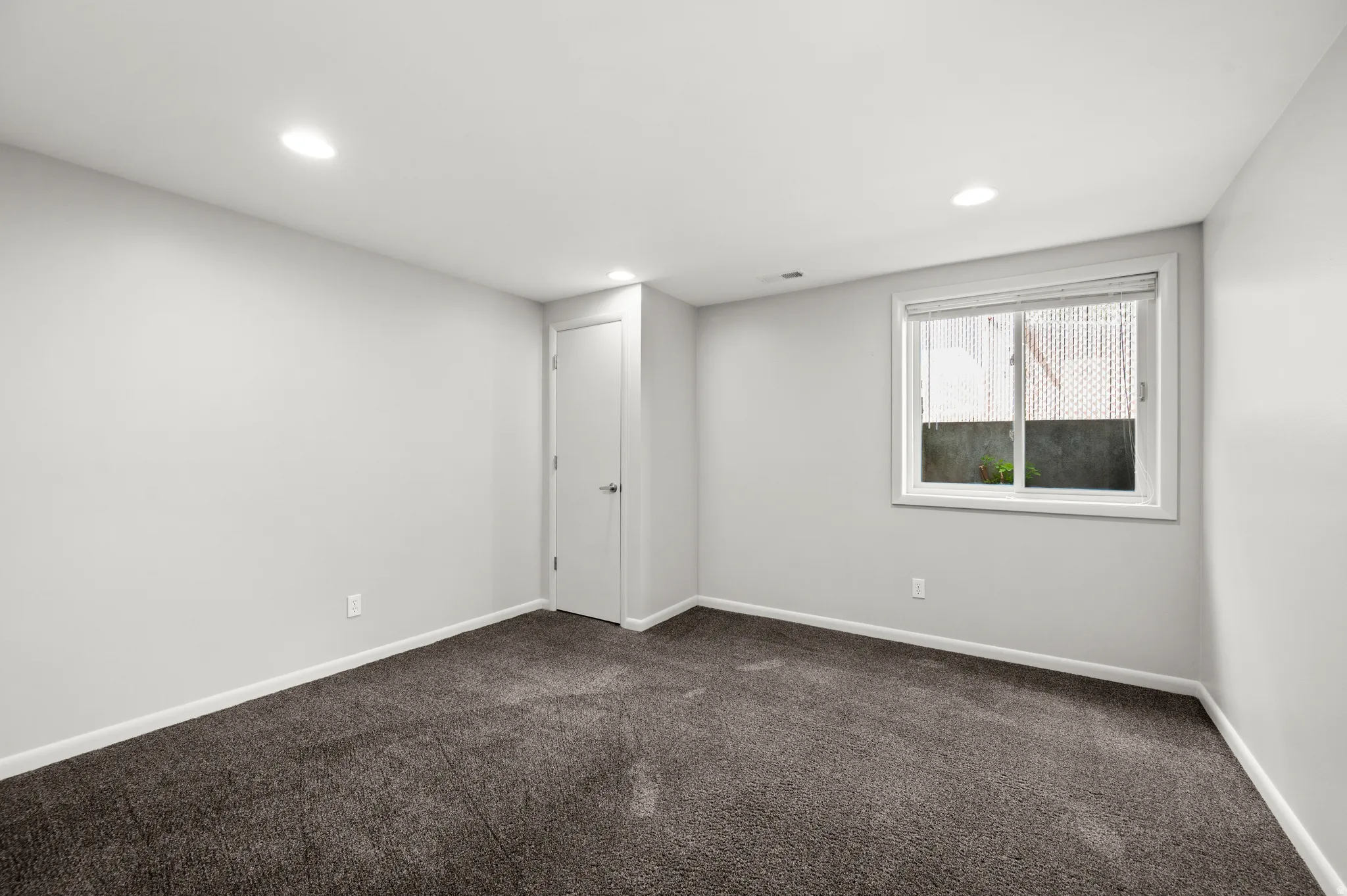 A comfortable lower-level bedroom offers additional private living space.