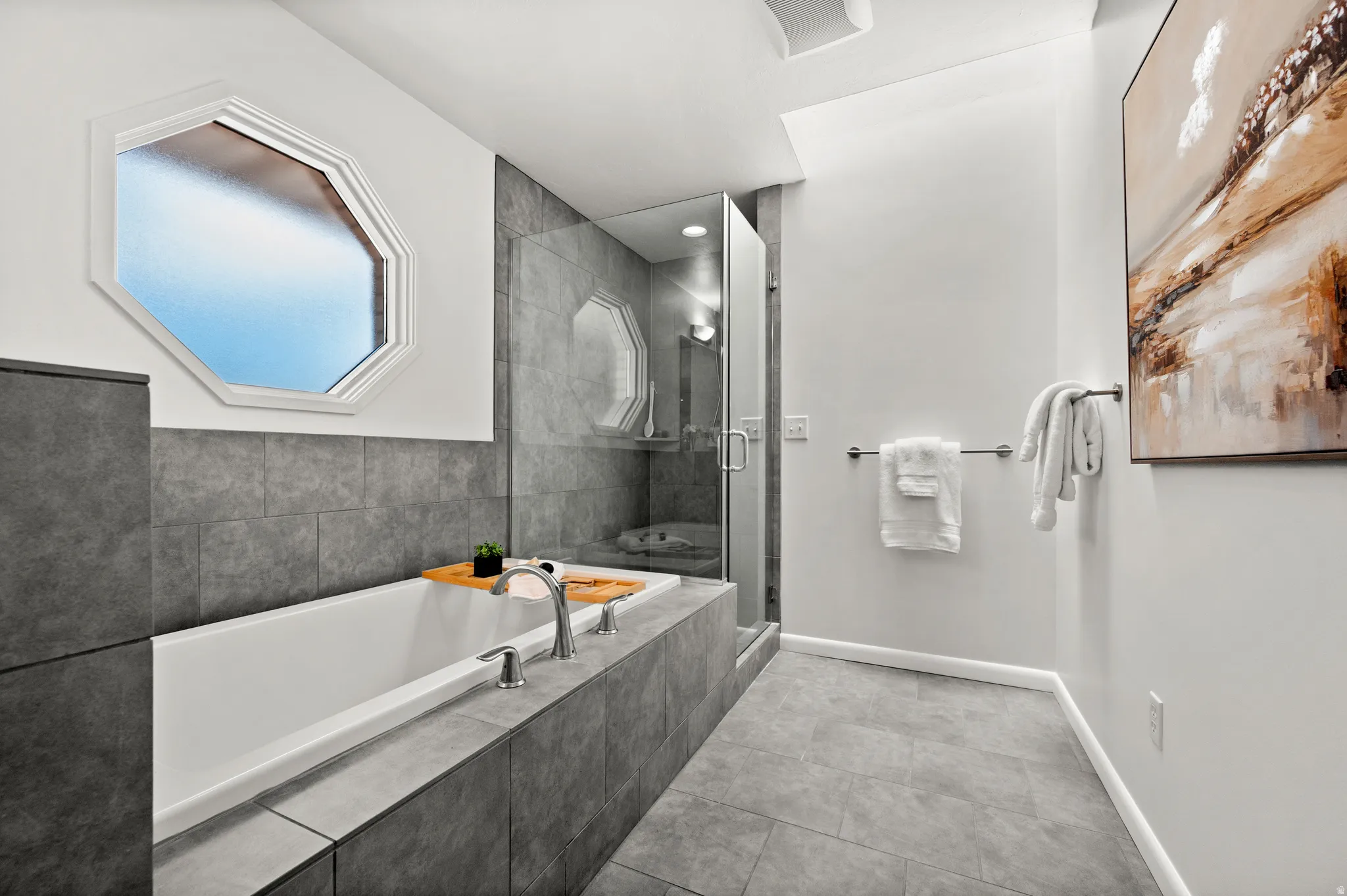 The primary bath includes a soaking tub and separate glass-enclosed shower.