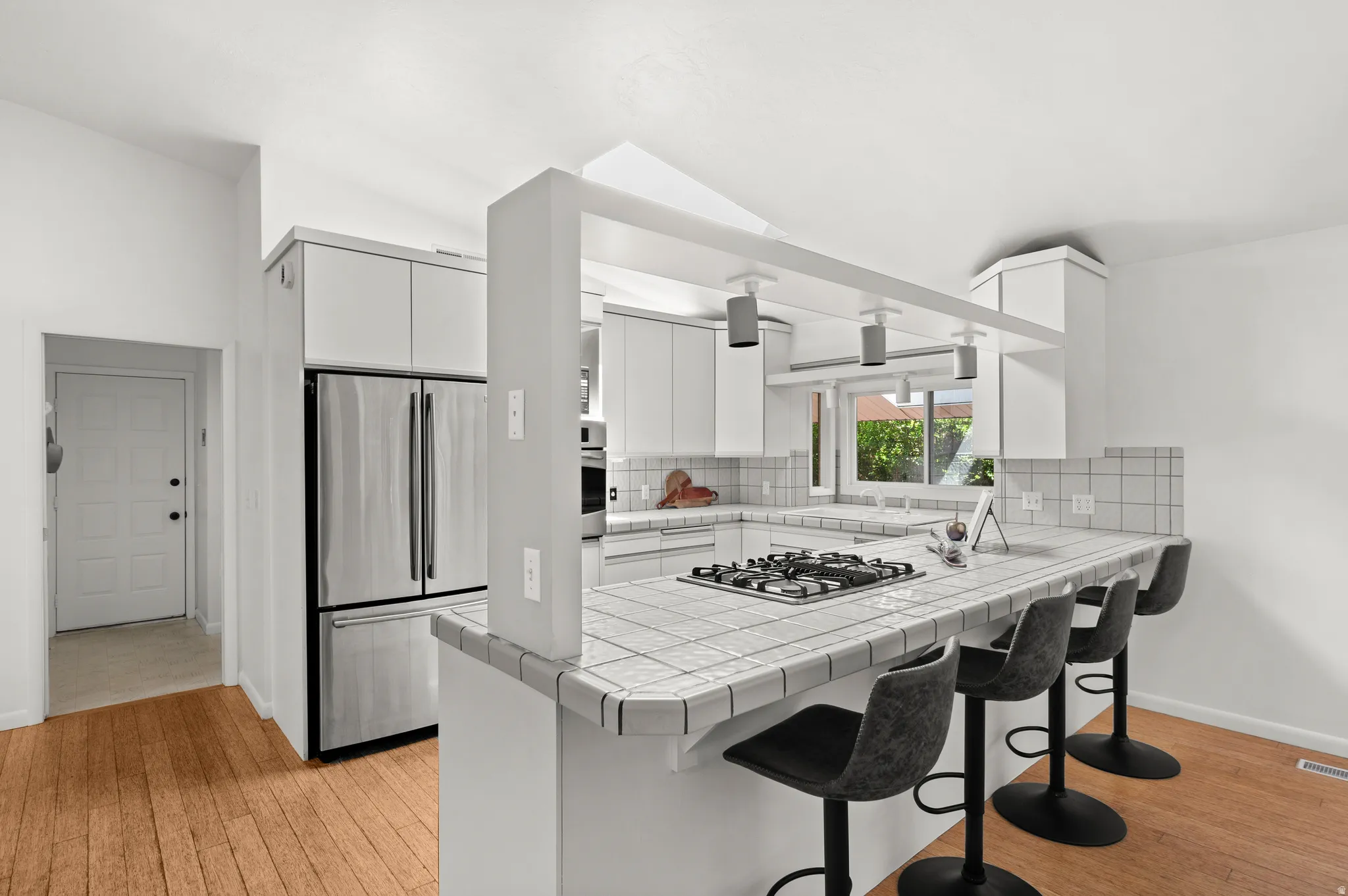 Generous counter space and peninsula seating make the kitchen equally suited to everyday living and gathering.