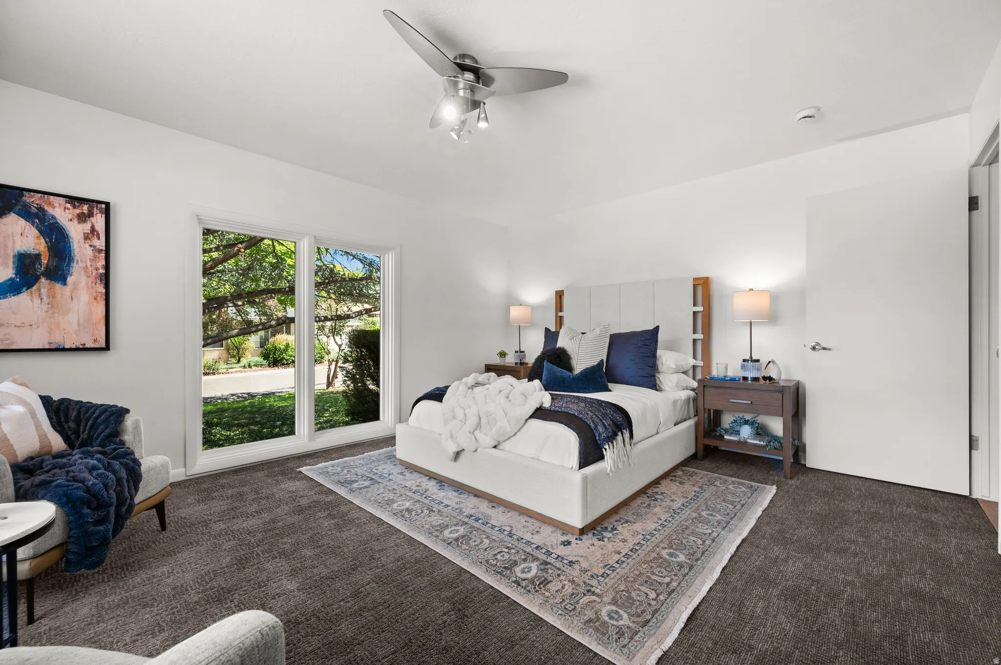 A second view highlights the bedroom's generous proportions and abundant natural light.