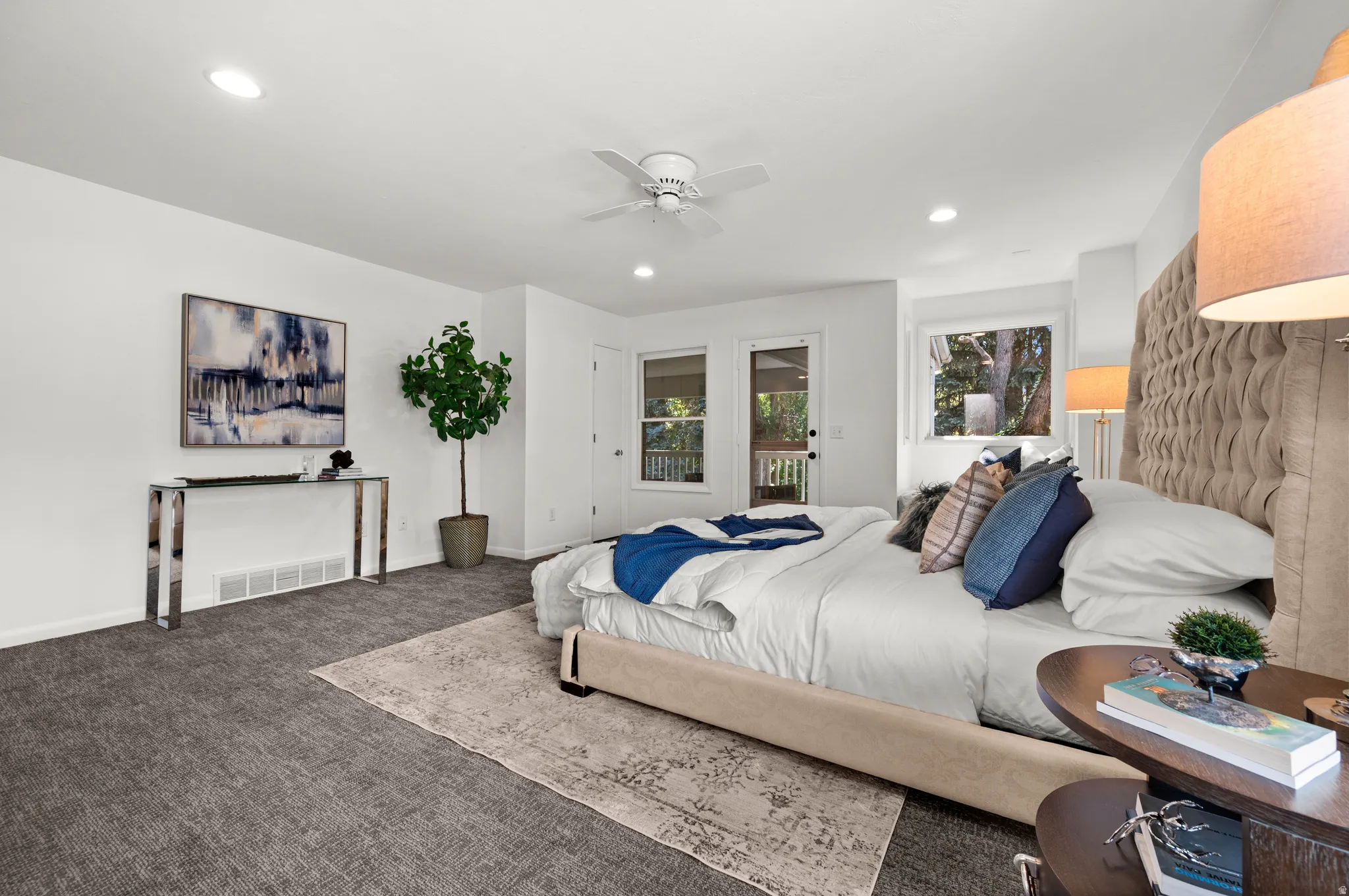 A wonderfully spacious primary suite with room for a sitting area and a peaceful connection to the outdoors.