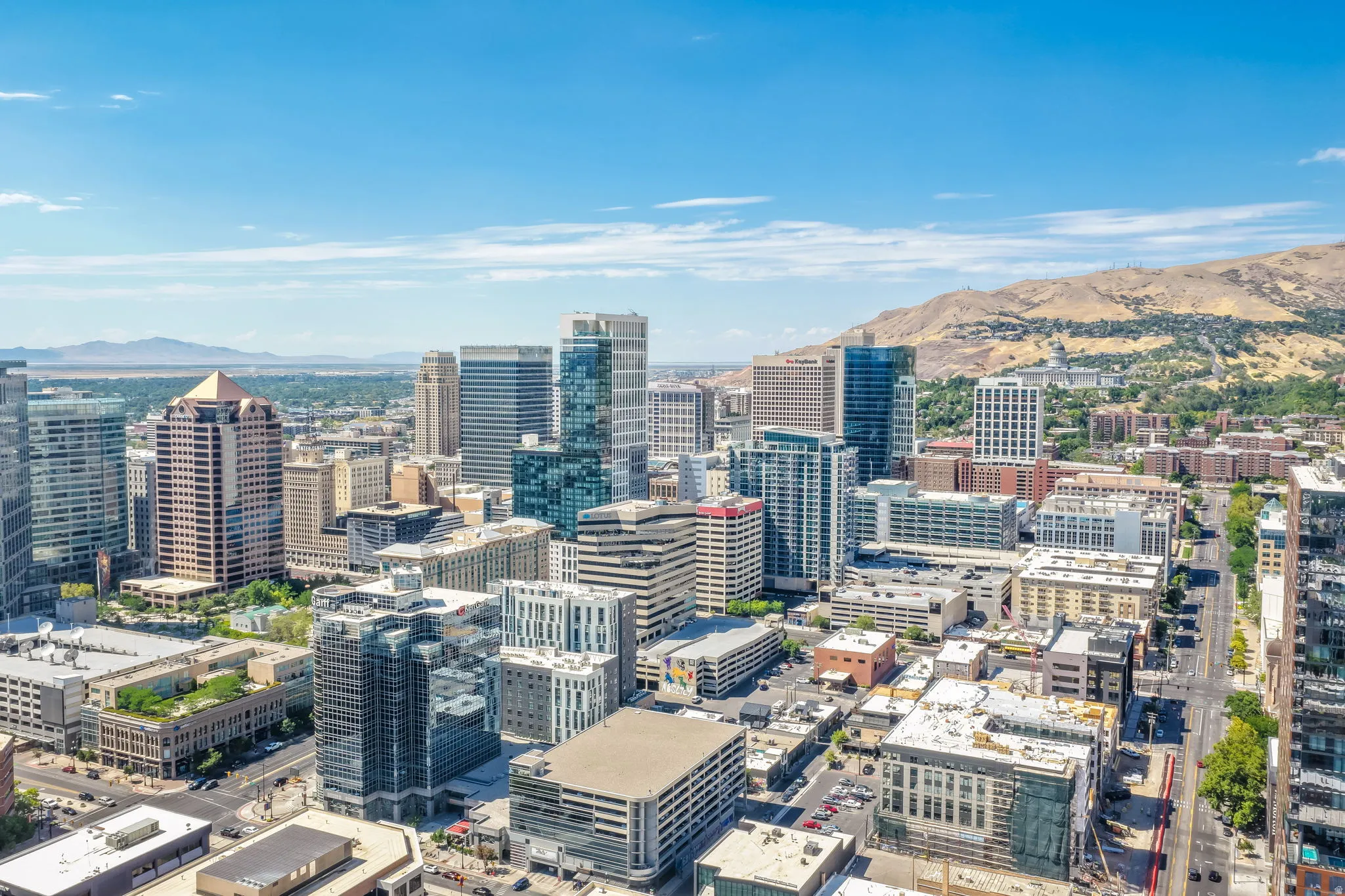 Expansive urban landscape with a dynamic mix of high-rise and mid-rise structures, featuring a prominent mountain backdrop