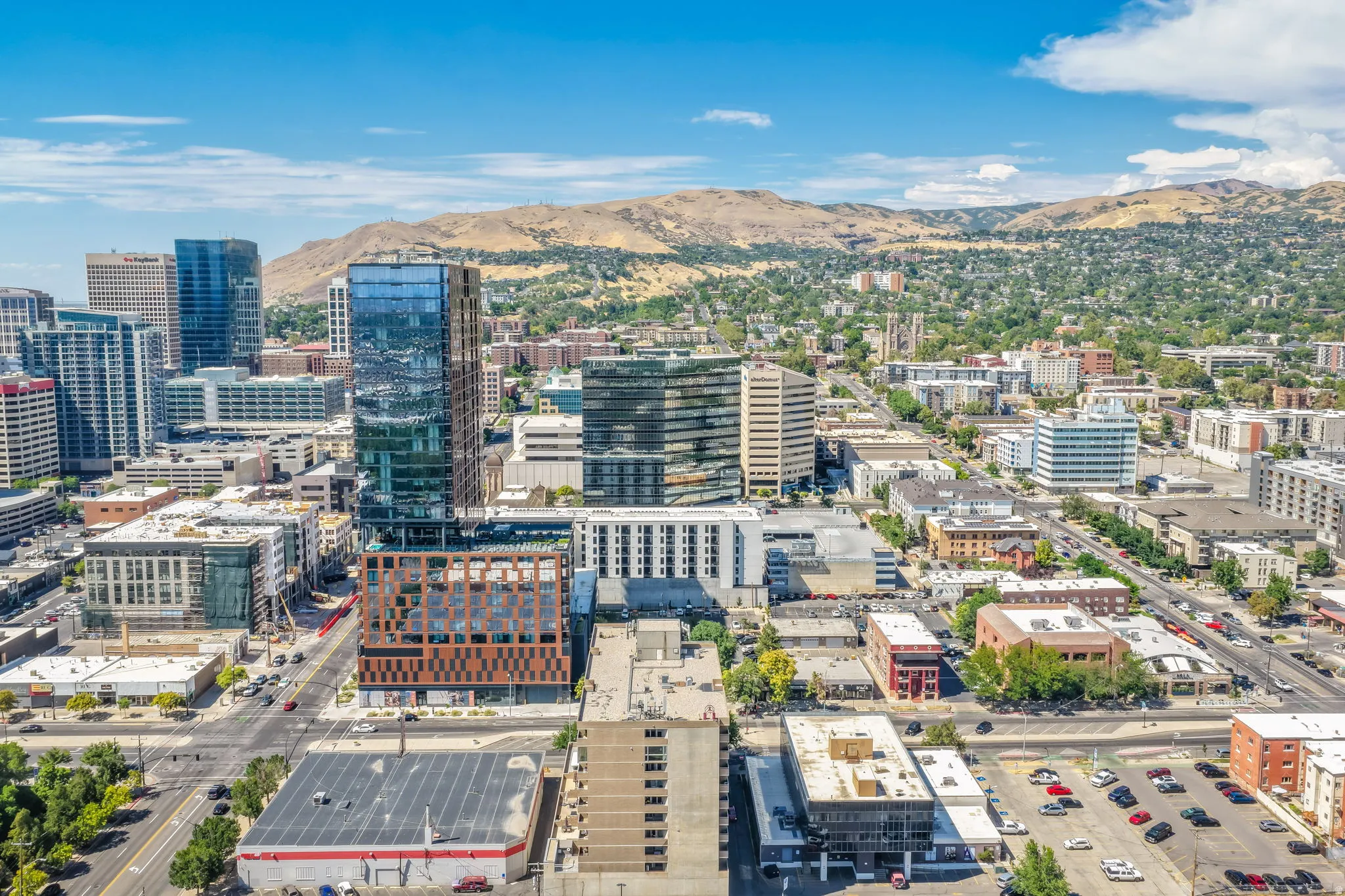 Expansive urban landscape with a mountain backdrop, showcasing a mix of high-rise and mid-rise buildings