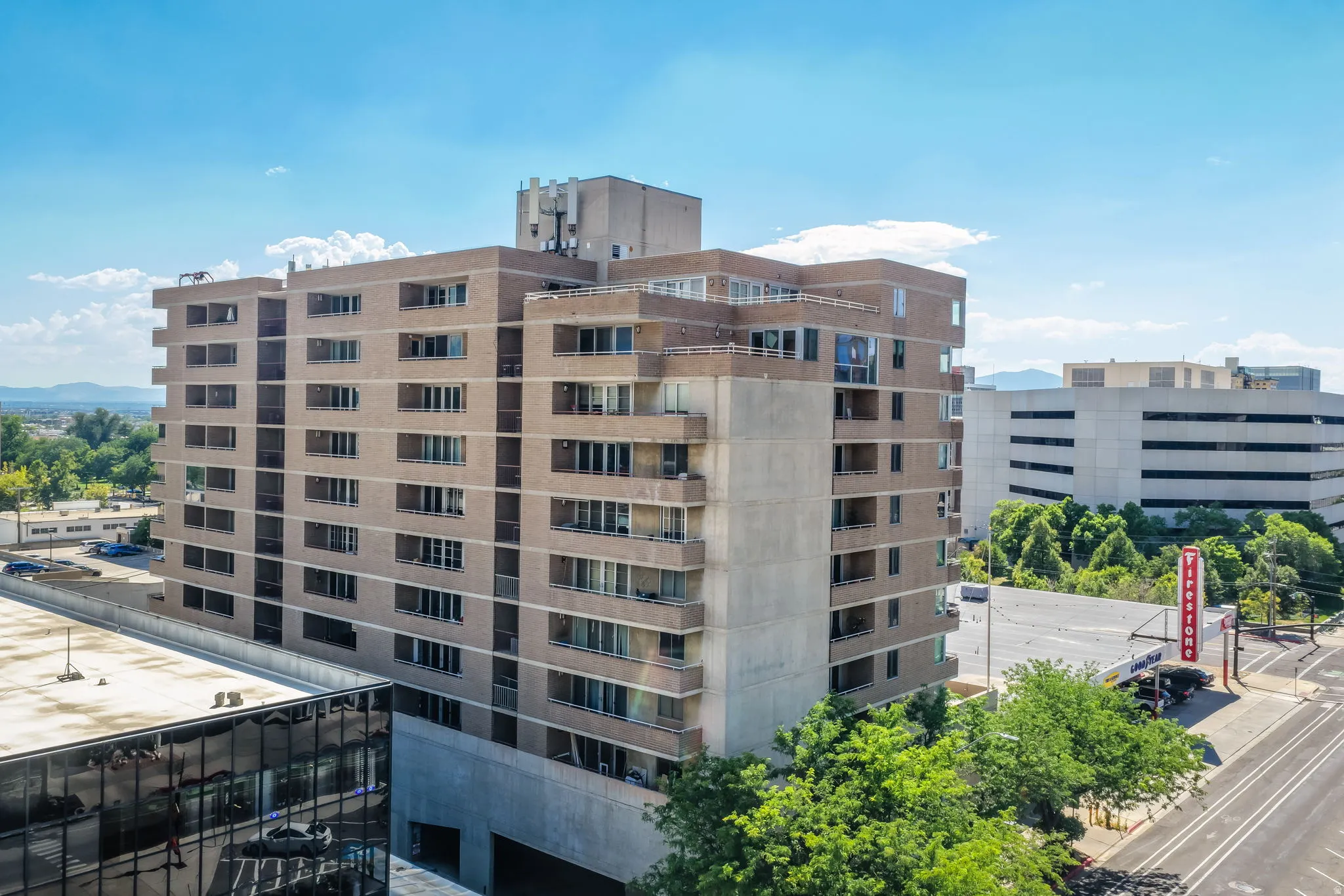 Multi-story building featuring brick and concrete exterior with multiple balconies