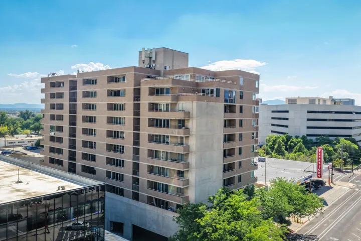 Multi-story building featuring brick and concrete exterior with multiple balconies