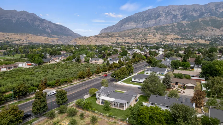 Mountain backdrop, residential street, mature trees, suburban setting, well-defined lot