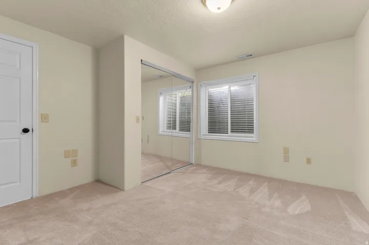 Wall-to-wall carpeting and neutral wall tones