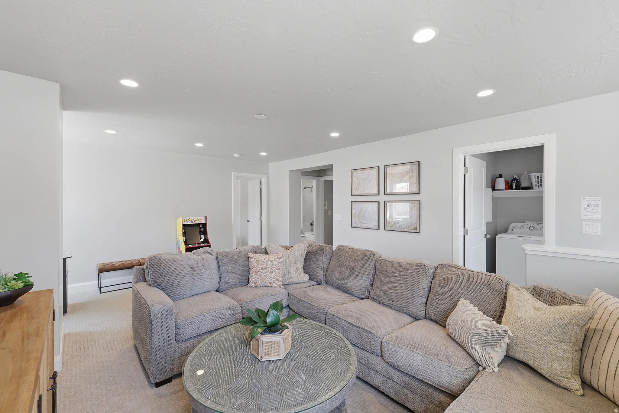 Recessed lighting, light-toned walls, and carpeted flooring