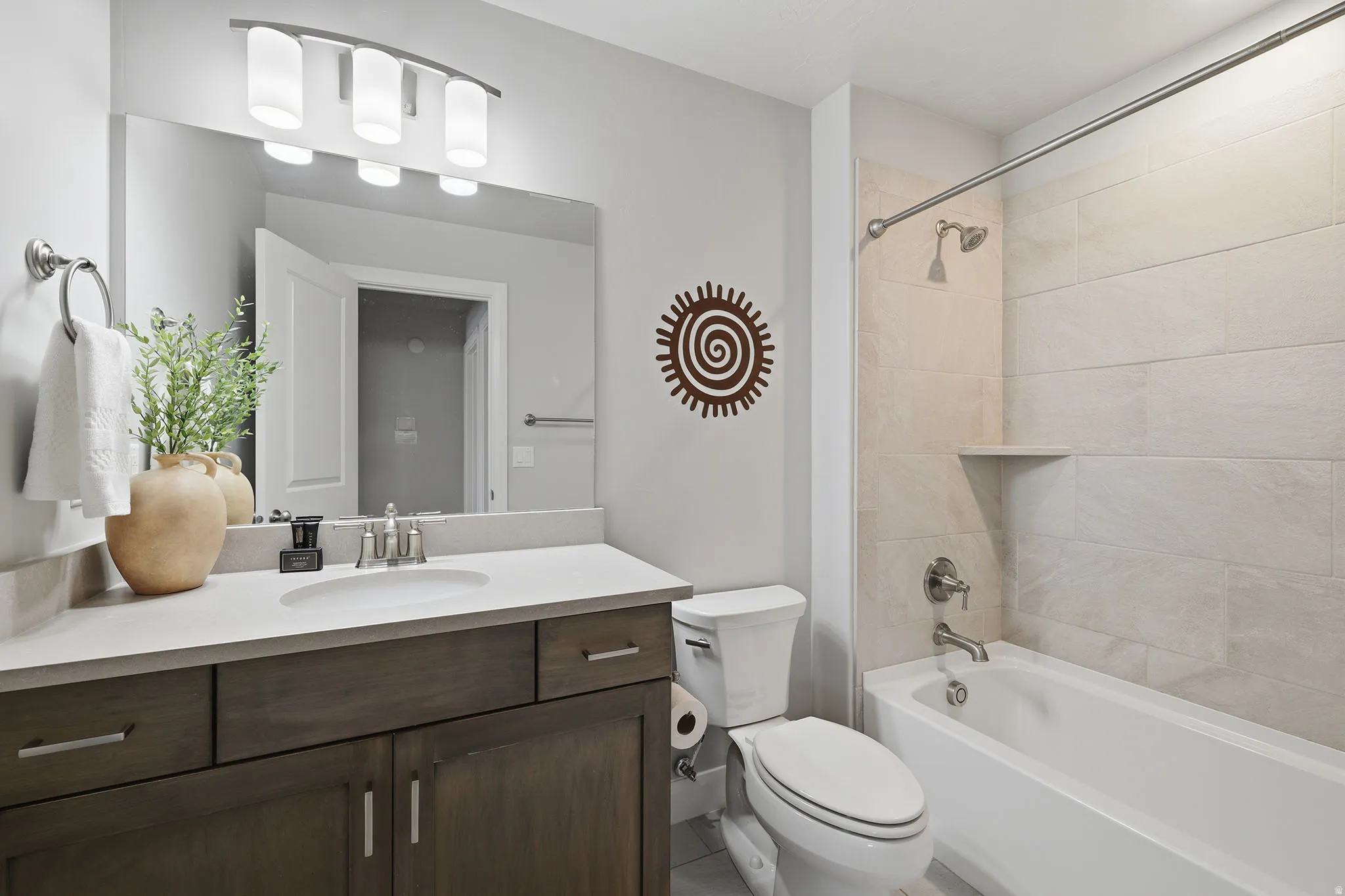 Vanity with undermount sink and light-toned countertop