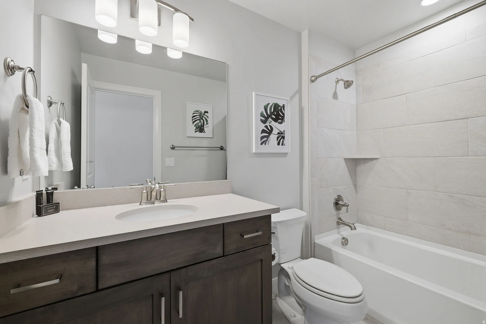 Spacious vanity with an integrated sink and brushed nickel hardware