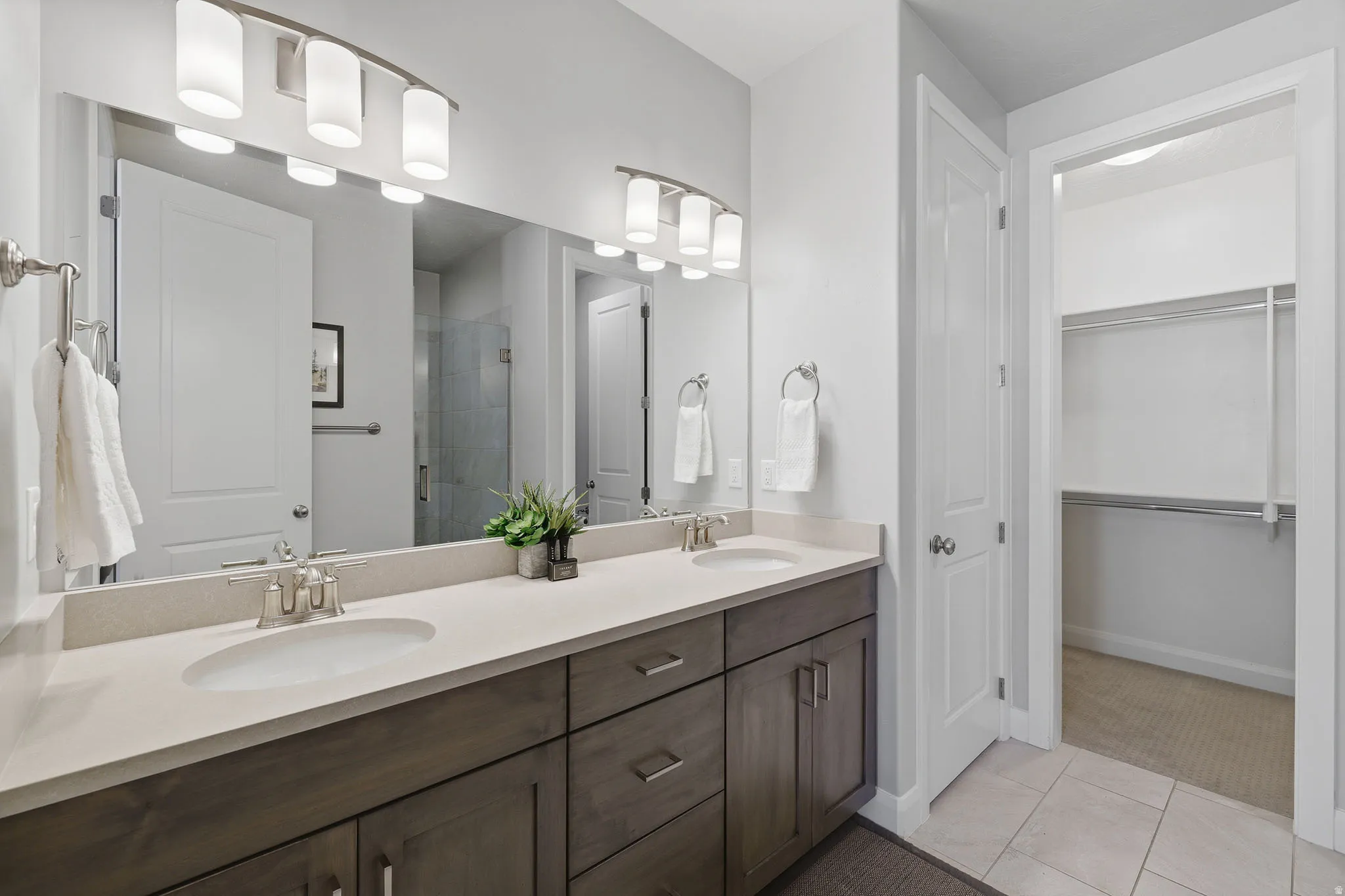 Dual vanity with integrated sinks and brushed nickel fixtures