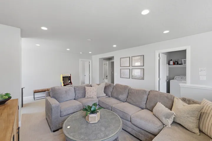 Recessed lighting, light-toned walls, and carpeted flooring