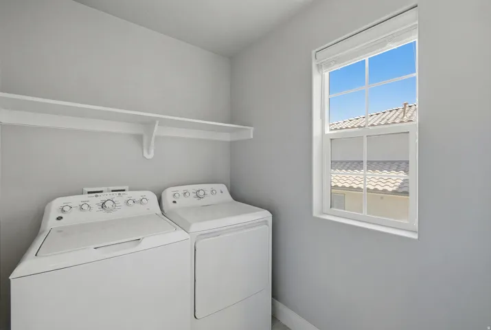 White wall-mounted shelving unit, double-pane window with white trim, and light gray wall paint