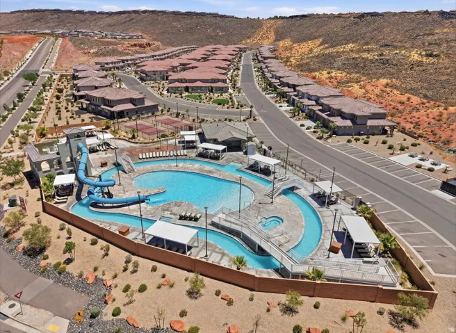 Central community amenity area featuring a large swimming pool, lazy river, and water slide