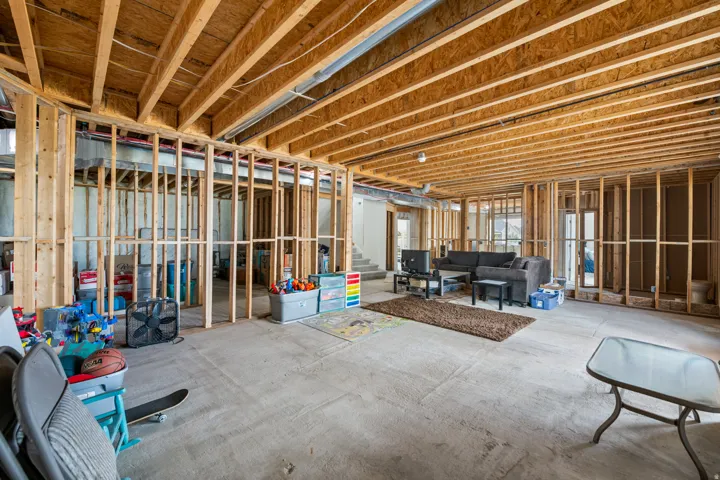 Unfinished lower level with wood framing and exposed ceiling joists