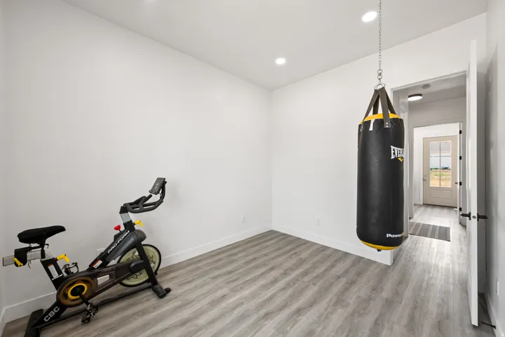 Recessed ceiling lighting, durable wood-finish flooring, and a neutral color palette