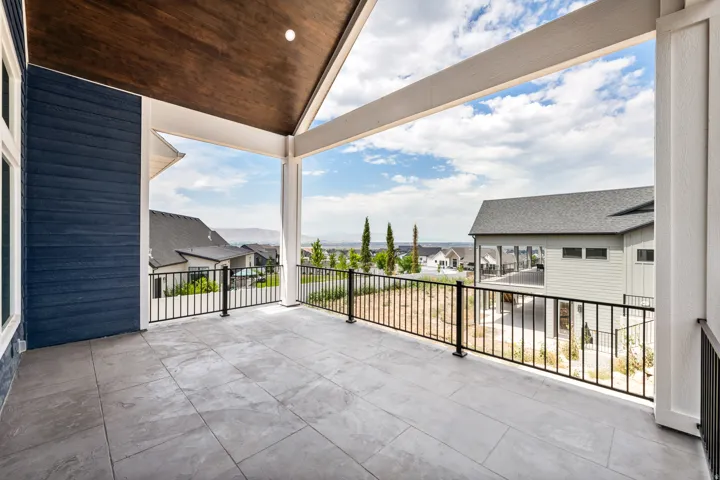 Covered patio featuring a slatted wood ceiling, recessed lighting, and a durable tile floor