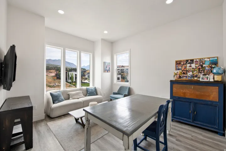 Bright interior featuring recessed ceiling lighting, light wood-finish flooring, and multiple tall windows