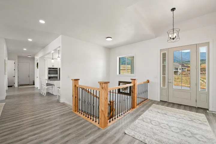 Light wood-finish flooring with white walls