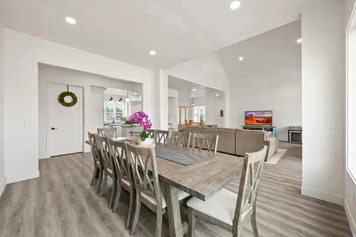 Recessed lighting illuminates the wood-finish flooring and vaulted ceiling