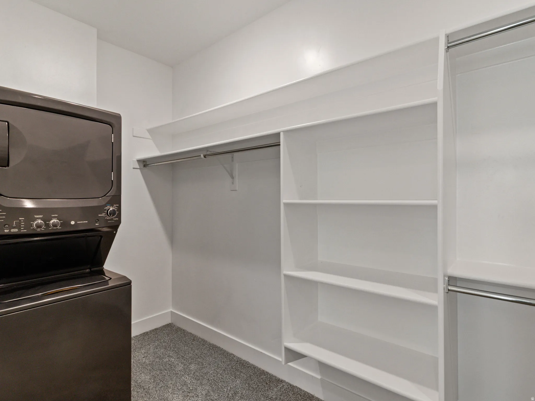 Built-in shelving, hanging rods, and integrated stackable laundry appliances