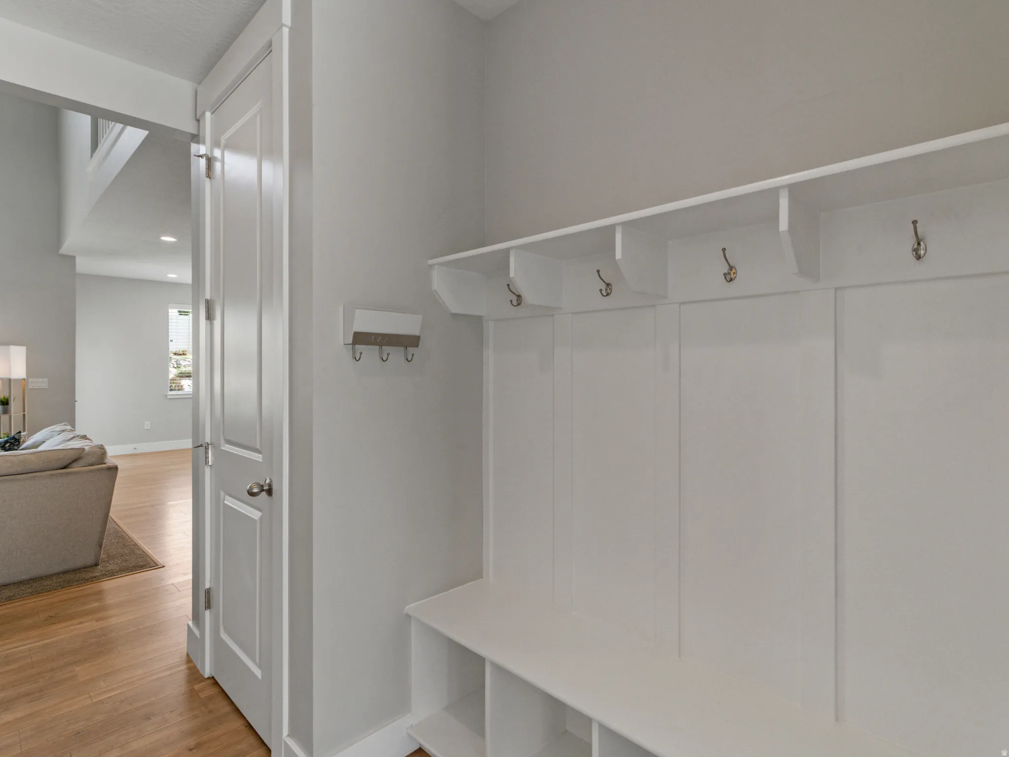 Built-in mudroom bench with cubby storage and individual coat hooks