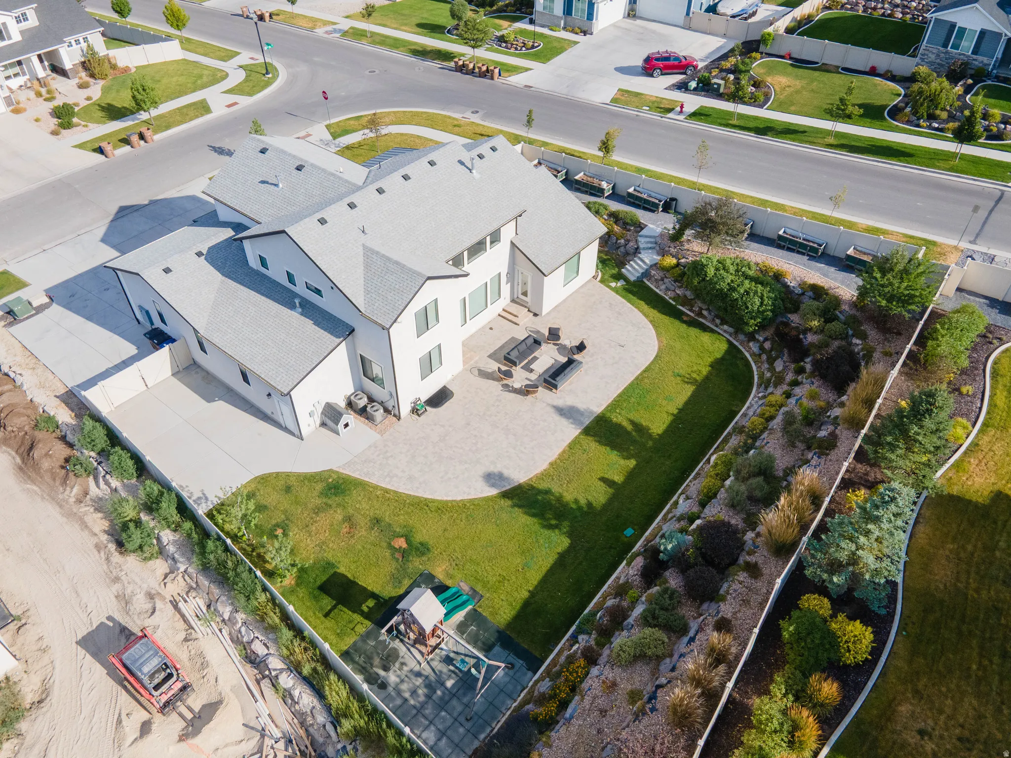 Expansive backyard featuring a manicured lawn, an amenity area, and a built-in play structure