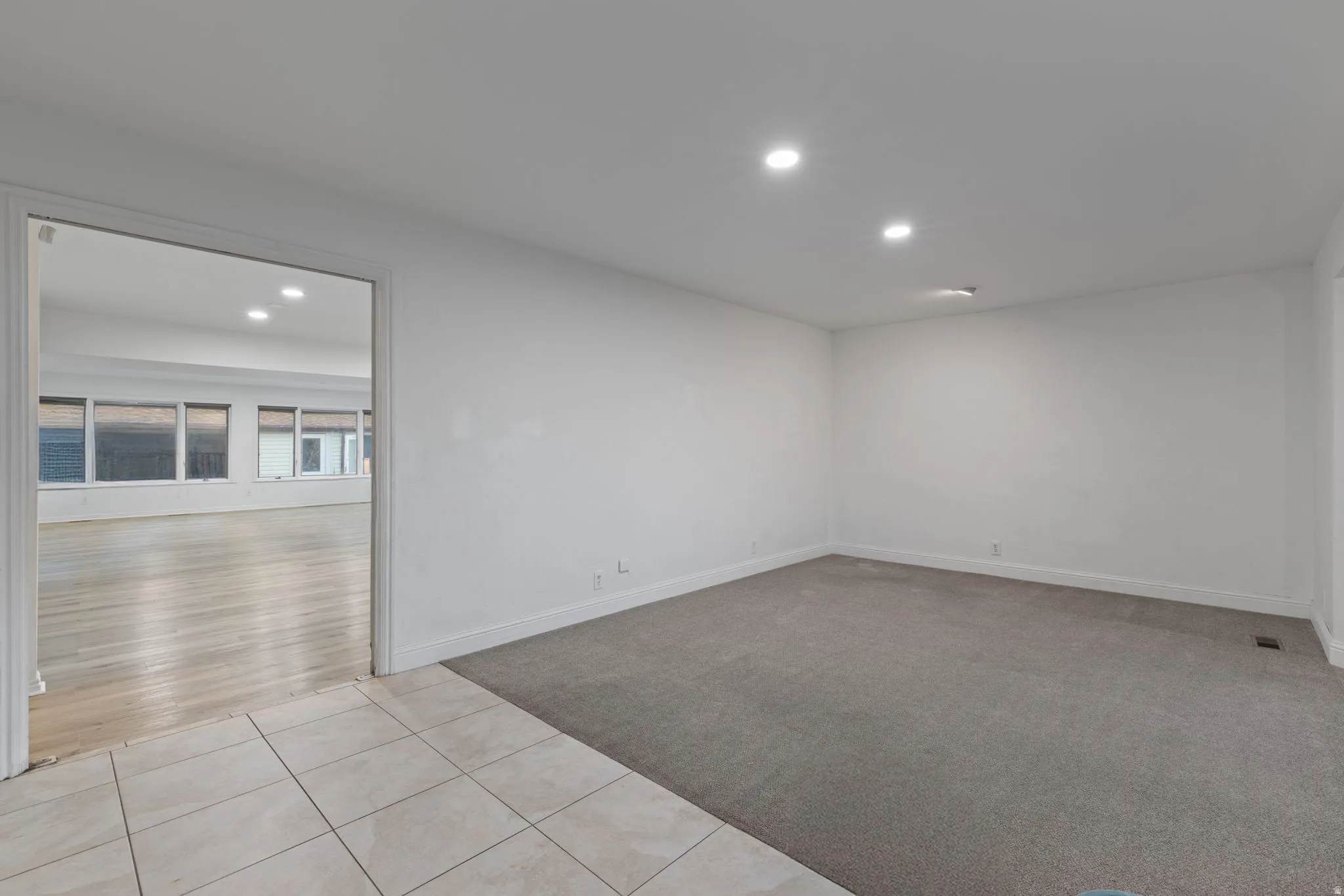 Recessed lighting, tile flooring, wall-to-wall carpeting, and wood-finish flooring