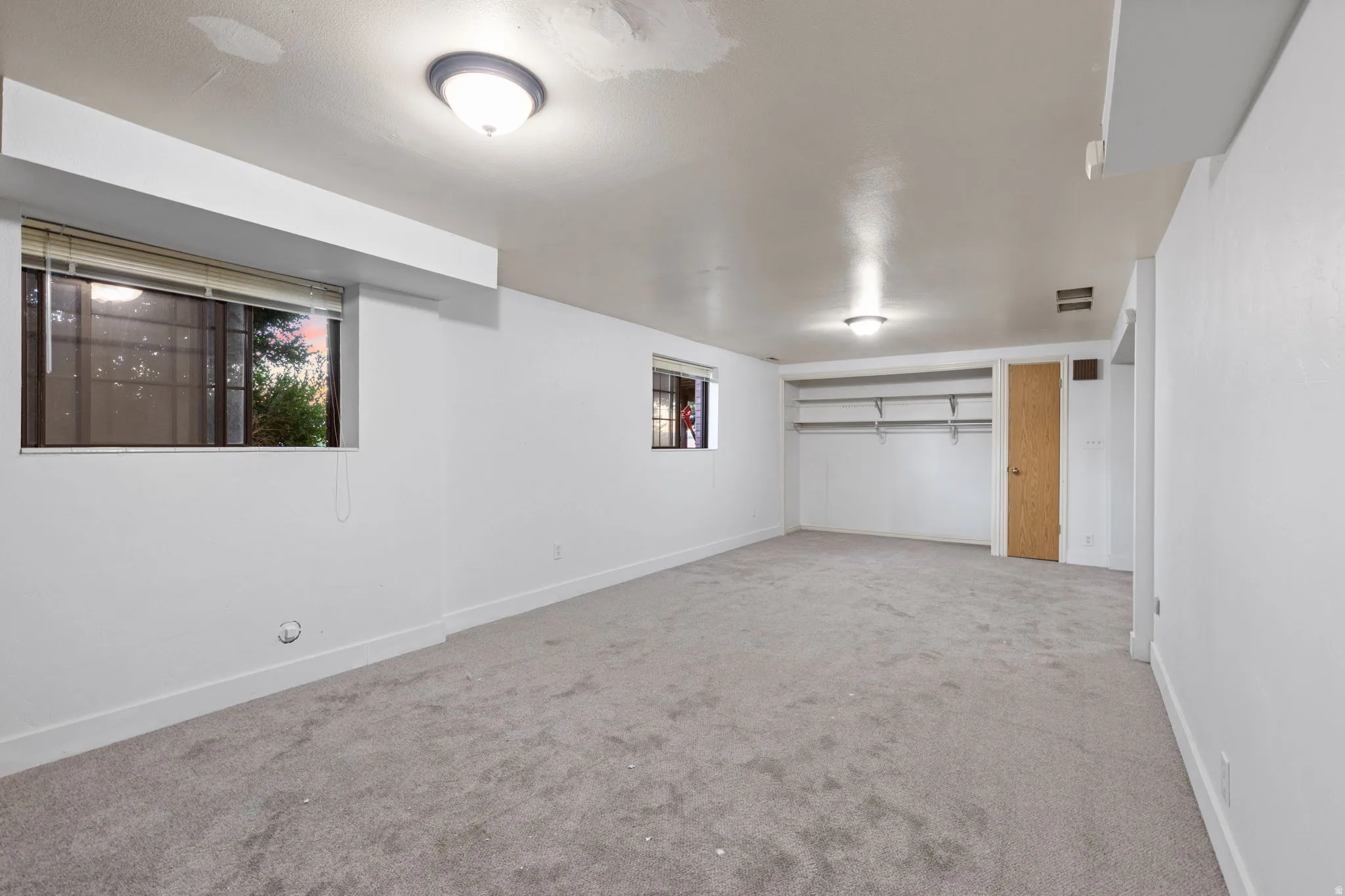 Wall-to-wall carpeting, dual windows, and built-in closet shelving