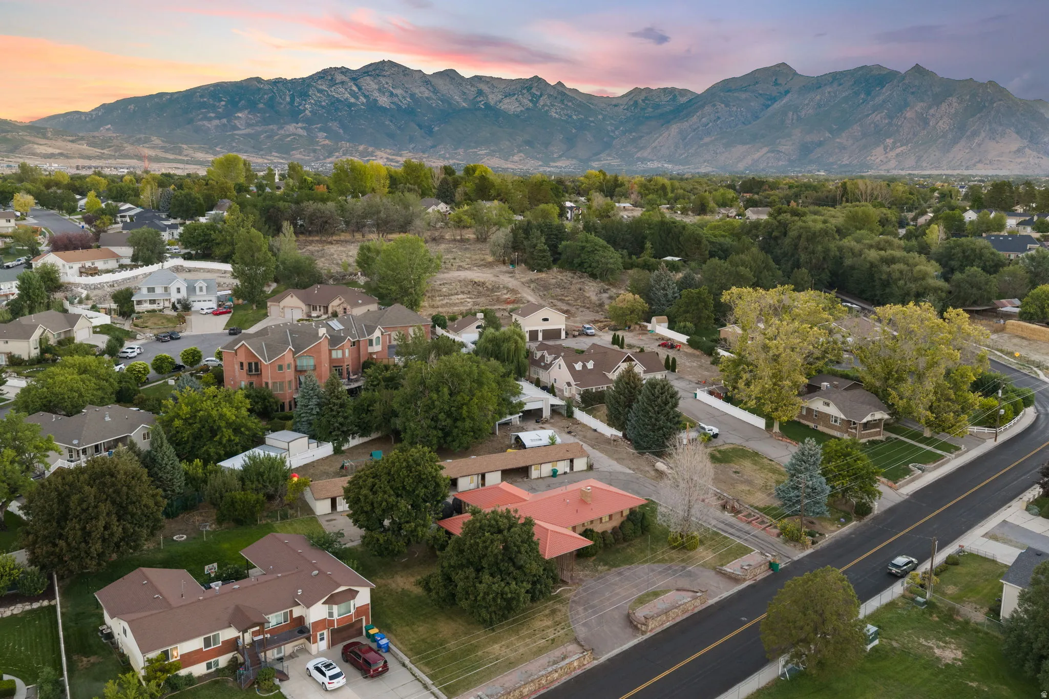 Residential area with established trees and mountain backdrop