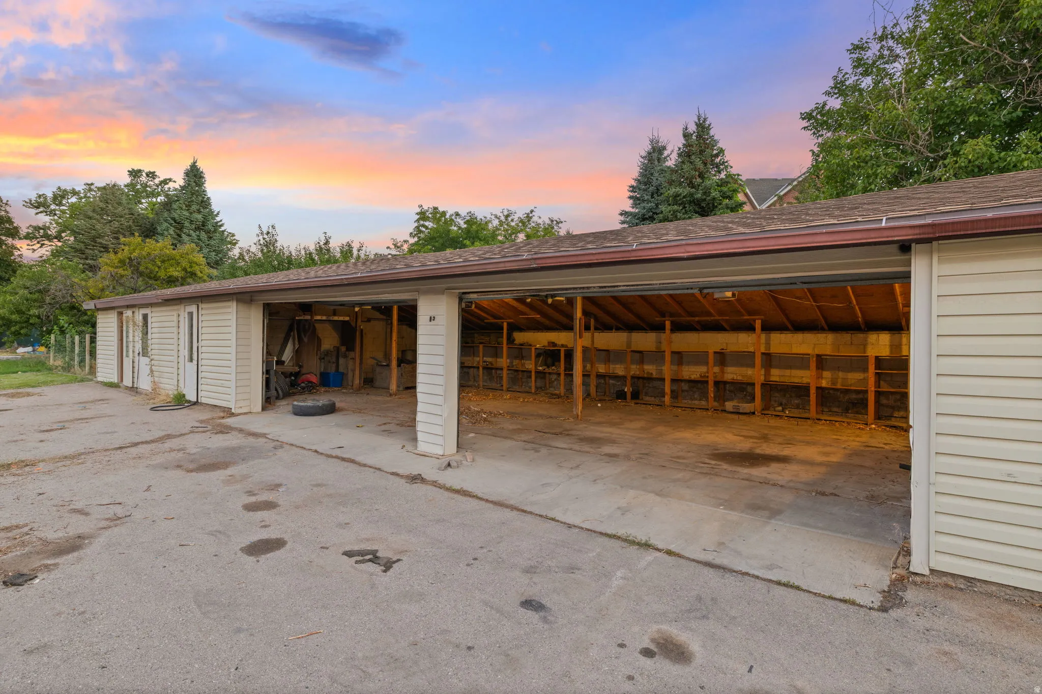 Multi-bay garage structure with vinyl siding and a shingle roof